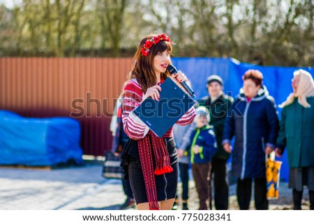 Girl with a microphone speaks to viewers Royalty-Free Stock Photo #775028341