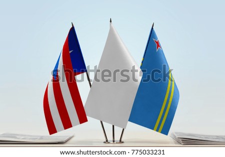 Flags of Puerto Rico and Aruba with a white flag in the middle