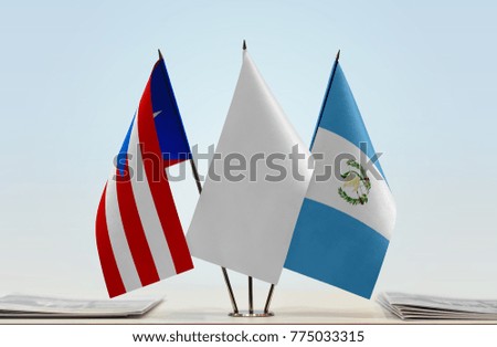 Flags of Puerto Rico and Guatemala with a white flag in the middle