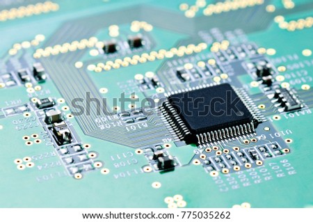 Integrated microchip on green circuit board.