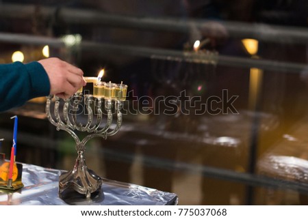 Men lightning the Hanukkah menorah  religious Jewish holiday  
