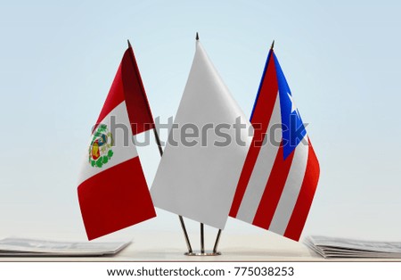 Flags of Peru and Puerto Rico with a white flag in the middle