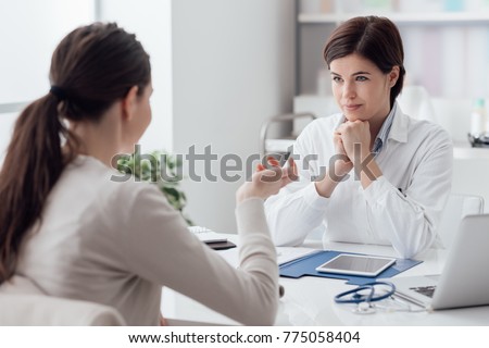 Doctor working in the office and listening to the patient, she is explaining her symptoms, healtcare and assistance concept Royalty-Free Stock Photo #775058404