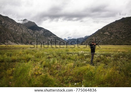 photographer takes a pictures of the nature by the SLR camera