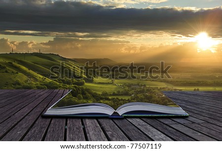 Beautiful sunset view across countryside spills out of magical book and creates stunning landscape background Royalty-Free Stock Photo #77507119