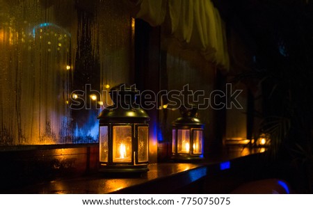 Burning lanterns in a dark room.