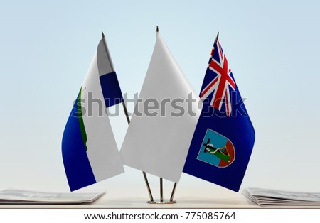 Flags of Navassa Island and Montserrat with a white flag in the middle