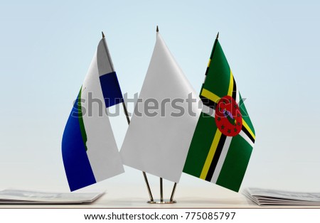 Flags of Navassa Island and Dominica with a white flag in the middle