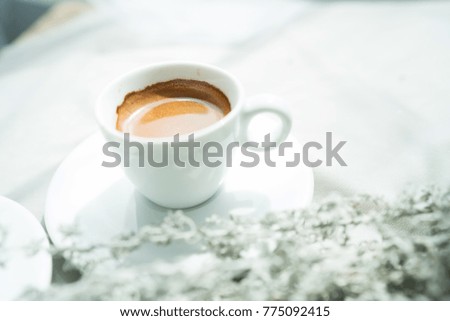 A white cup of espresso coffee in morning