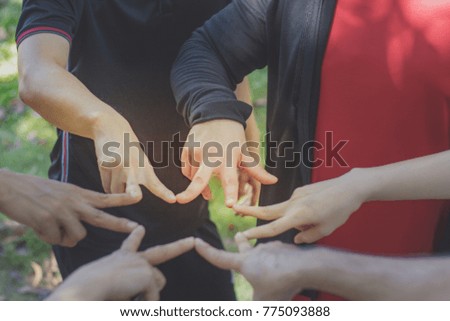 Young people show symbolic hand for promised purpose to achieve the goal. teamwork stacking hand concept, hands assemble together.