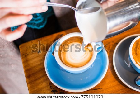 Barista Pouring Flat White Coffee Royalty-Free Stock Photo #775101079