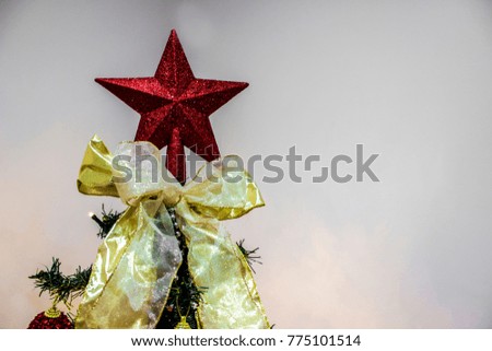 Red Christmas Star on top of Christmas Tree.