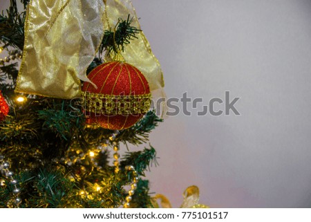Close-up of colorful xmas balls with Christmas tree in background. Christmas and New Year concept