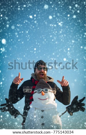new year christmas snow concept christmas man and snowman pilot in aviation glasses outdoor, new year and xmas holiday, party celebration, flight and travel
