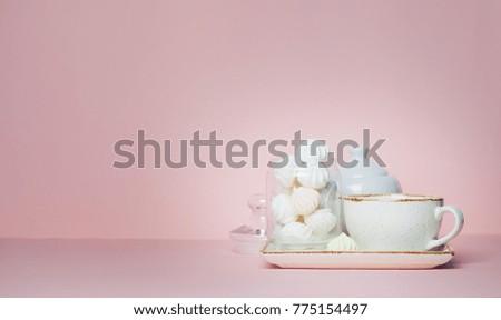Mock up of Cup of tea and meringues on pink background.
