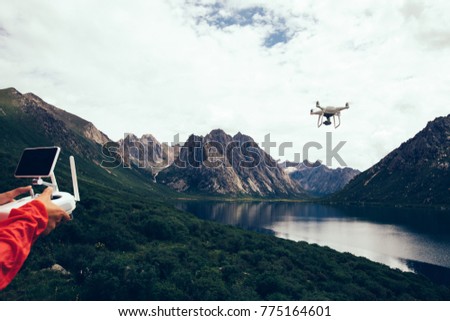 asian woman photographer flying drone outdoors