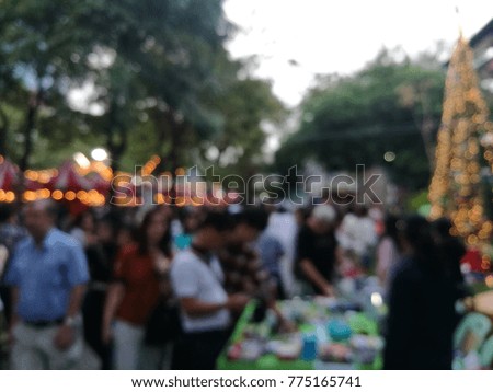 Christmas market blur background with light decoration, kiosk, shop and crowd