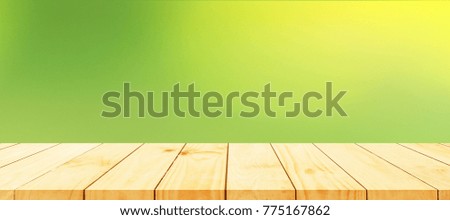 Wood table top on bokeh abstract green background for montage or display or products