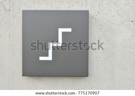 A stairs sign on the wall