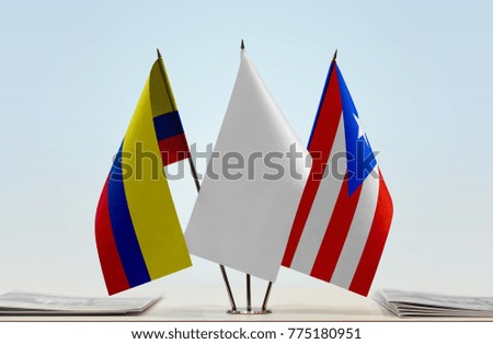 Flags of Colombia and Puerto Rico with a white flag in the middle
