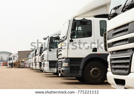 lorries parked up outside a company's car parking area ready to deliver goods to customers no people stock photo Royalty-Free Stock Photo #775221112