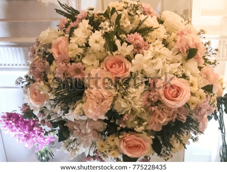 Fresh eustoma flowers and roses bouquet composition on a glass vase, wedding bridal decor