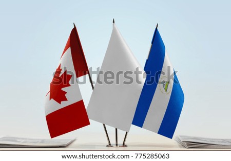 Flags of Canada and Nicaragua with a white flag in the middle