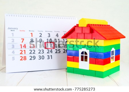 January 17th. Day 17 of month on white calendar and a colorful toy house. Day of childrens inventions