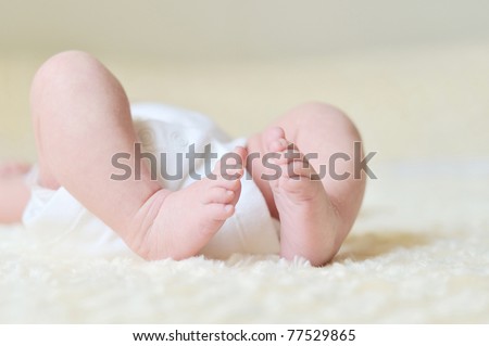 tiny foot of newborn baby in soft selective focus