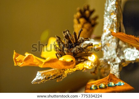 Dry pine cone and multi color leaves christmas tree natural decoration closeup. Christmas tree natural decorations can be used as background picture or greeting cards.