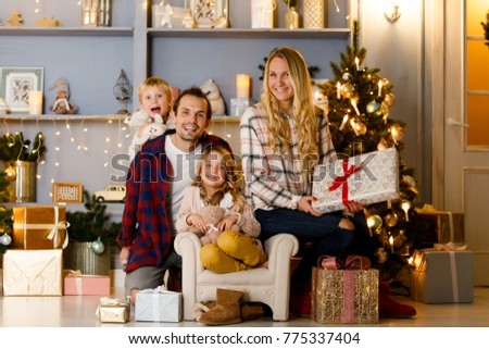 New Year's picture of happy family on background of Christmas decorations, pine