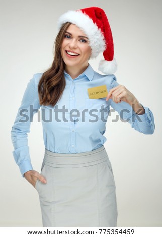 Santa Girl businesswoman holding gold credit card. Isolated studio portrait.