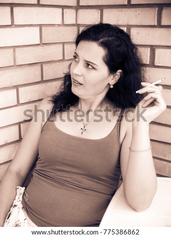 Mature beautiful brunette woman smoking, cigarette house background. Addiction and Quit smoking. The social problem among women
