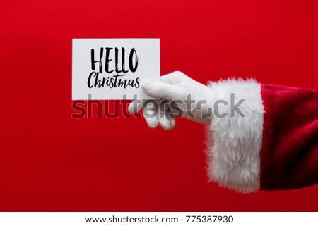 Santa Claus hand holding a Christmas sign