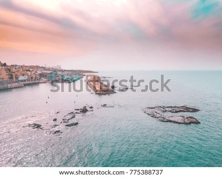 drone view of old city port from the ocean with rocks