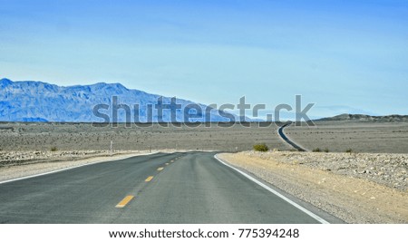 Rural desert road through Death Valley National Park. California. USA.