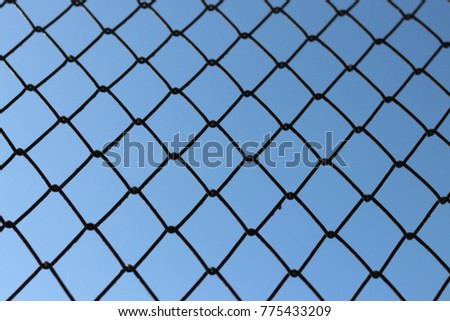 Metal net with blue sky