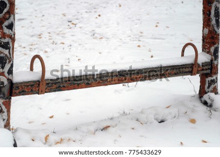 Children's playground covered with white and beautiful snow. Winter and autumn holiday background