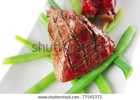 served roast fillet mignon on a white ceramic plate
