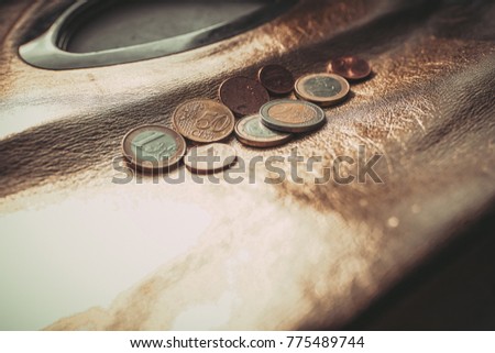 euro coins lie on a gold bag