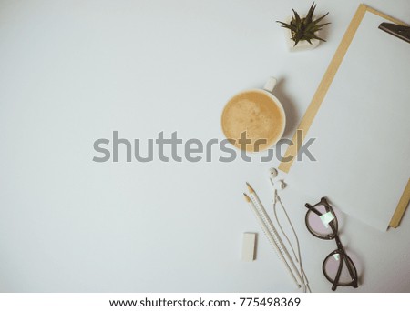 Minimal home desk workspace with clipboard, pen, coffee mug on white background. Flat lay, top view 