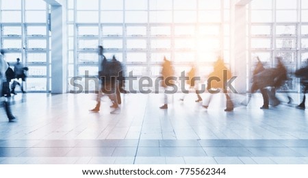 Blurred people walking in a modern environment