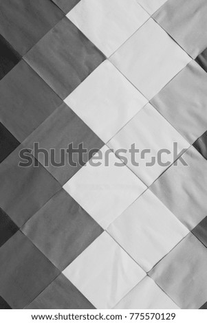 Beautiful black and white or monochrome of creative workings from the many square paper that are covered on the concrete wall texture and background for design and architect