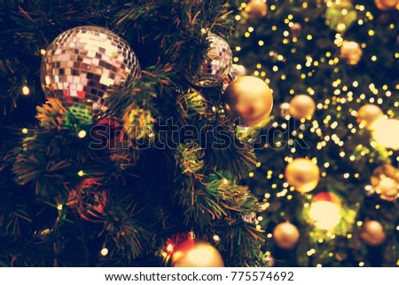 Decorated Christmas tree on blurred, sparkling background