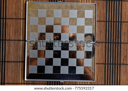 Photo with a picture of a steel chess Board. Metal board with reflection