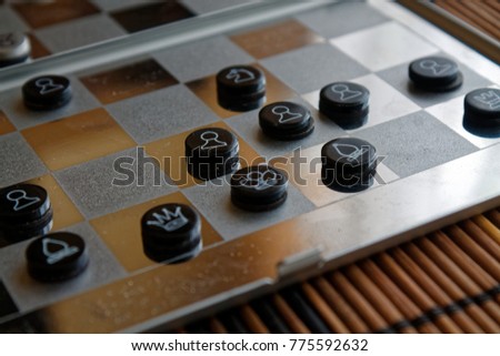 Photo with a picture of a chess steel Board and chess pieces, Metal chess pieces on a chess Board with reflection