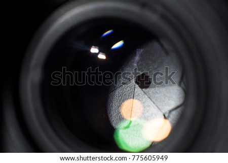 Lens aperture. The diaphragm of a camera lens aperture. Lens front side exposed aperture blades.