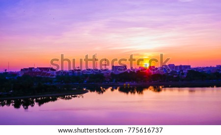 Sunrise over pond in a city