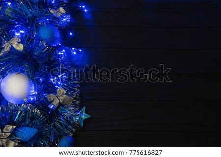The Christmas or the New Year background. Christmas tree decorations and fairy lights.