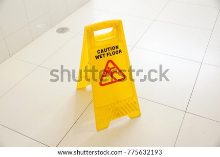 Caution wet floor sign on a toilet floor                